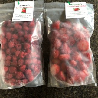 A bag of frozen raspberries and a bag of frozen strawberries.