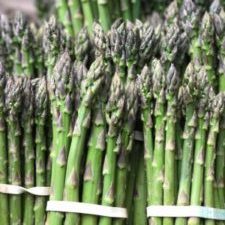 Bunches of asparagus spears lined up on display.