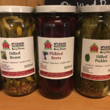 Three 500ml jars of pickles, from left to right: dilled beans, pickled beets, and dilled pickles.