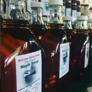 500ml glass jars of maple syrup, lined up on display.